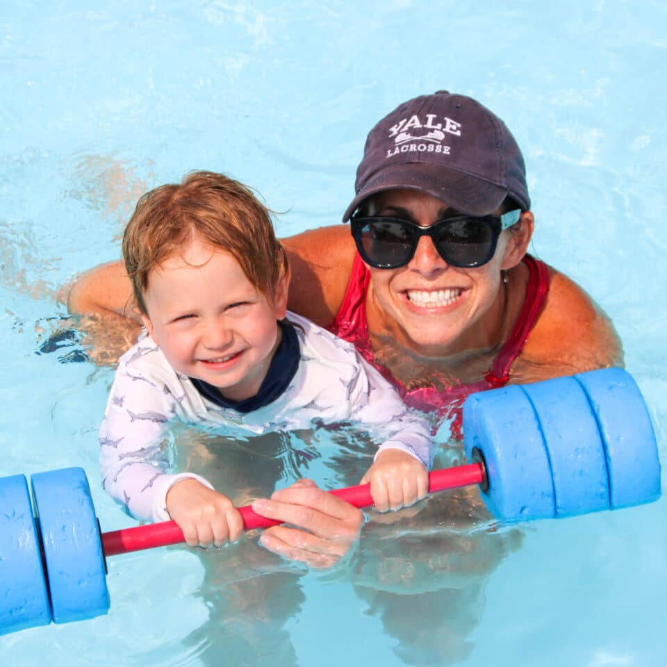 Pioneer camper with counselor in the pool.