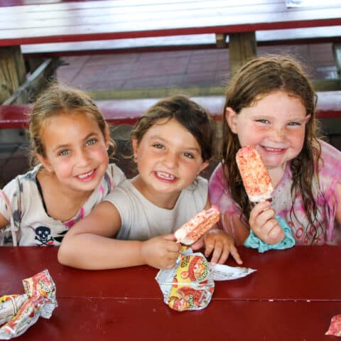 Pioneer campers eating popsicles together.