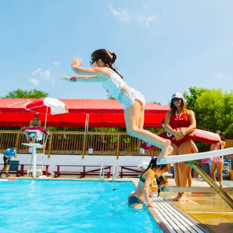 Scouts camper jumps off diving board into pool