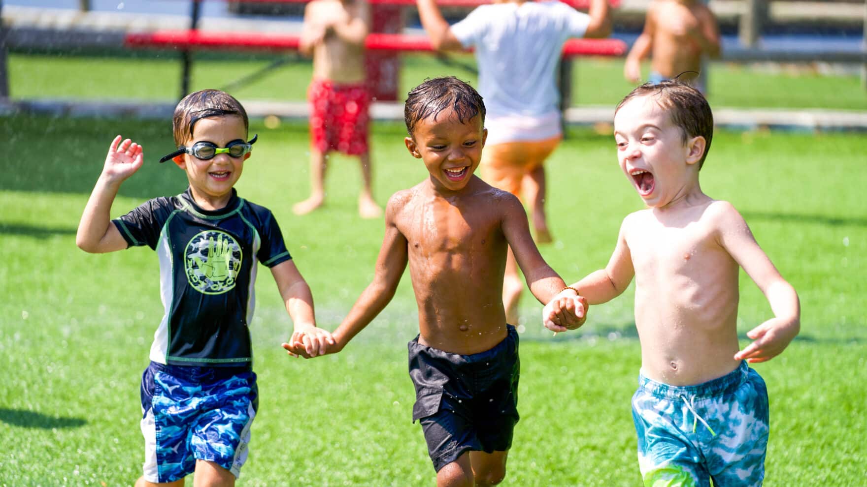 Scout campers running on the field having fun.