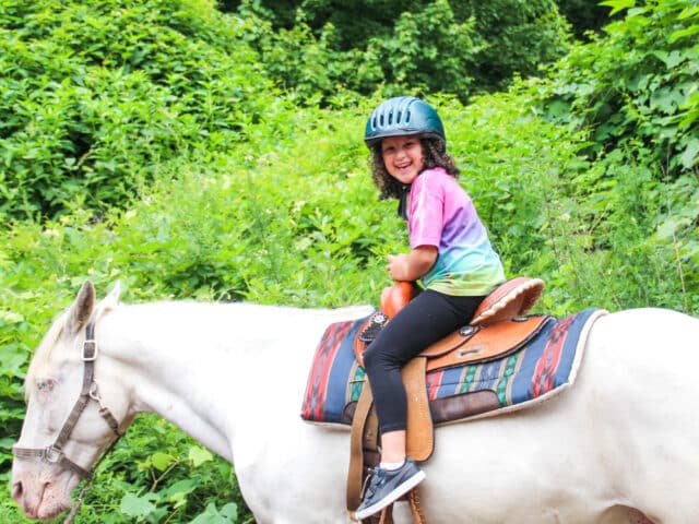 Young girl riding a horse