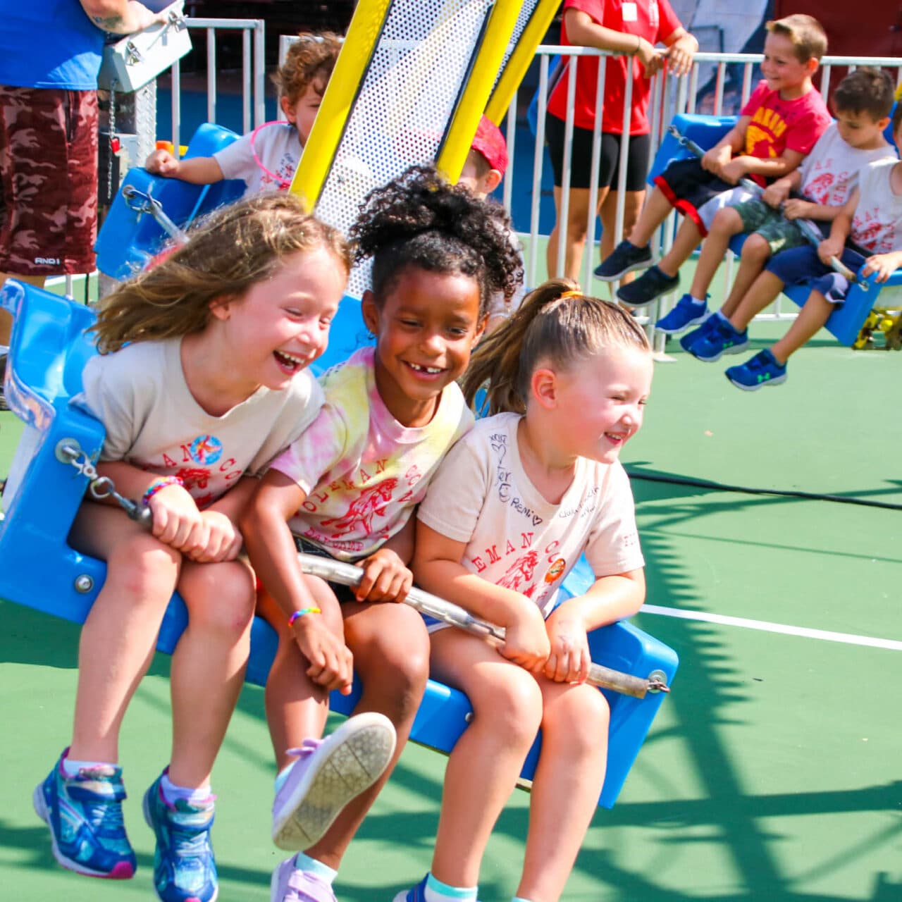 Young girls riding a fair ride.