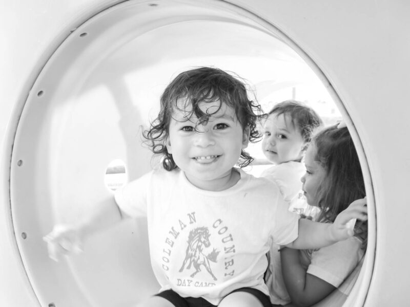 PIT campers in a playground tunnel.