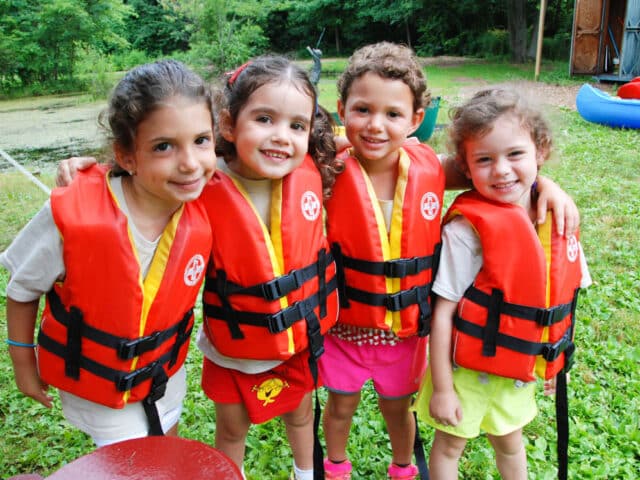 Four Pioneer campers in life vests.